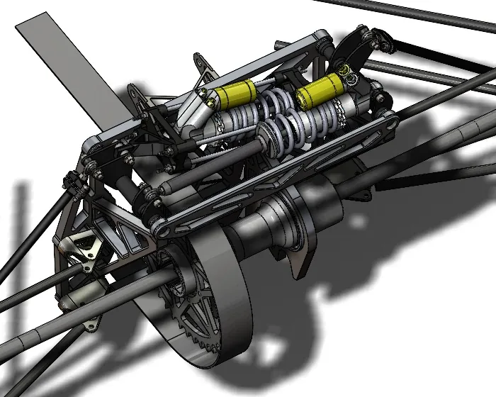 CAD render of the 2021 design's rear bulkhead assembly, cropped to the plates that carry the rockers and both spring-dampers, with the drive sprocket and brake disc below